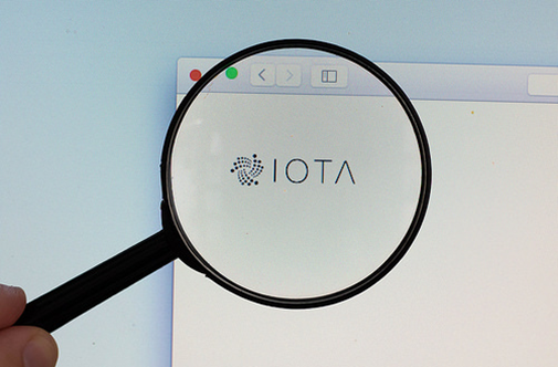 IOTA logo on a computer screen with a ma (CC BY 2.0) by marcoverch